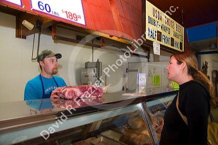 Woman shopping at a butcher shop in Boise, Idaho. MR
