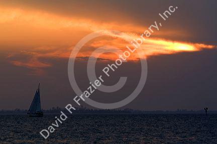 Sailboat and sunset at Fort Myers Beach on Estero Island in Lee County, Florida.