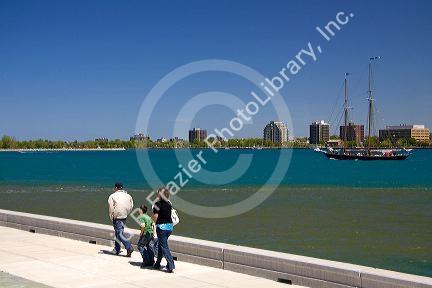 People walk along the St. Clair River at Port Huron, Michigan.