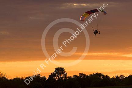 Powered parachute flying at sunset in Eaton County, Michigan.