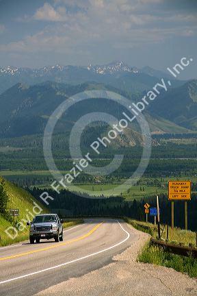 A truck traveling over the high mountain Teton Pass on Wyoming Highway 22 near the state border of Wyoming and Idaho.