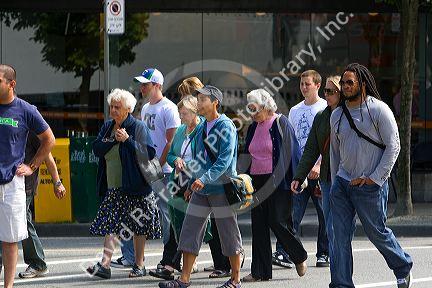 A diverse group of people crossing the street in Vancouver, British Columbia, Canada.