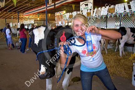 Girl showing her 4-H blue ribbon winning Holstein Cow at the Western Idaho Fair in Boise, Idaho. MR
