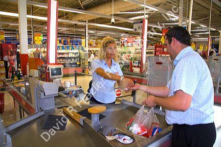 Customer purchasing groceries at a supermarket in the town of Guernica in the province of Biscay, Basque Country, Northern Spain.