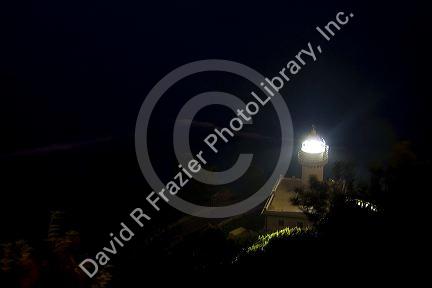 Monte Igueldo Lighthouse at night in La Concha Bay near the city of Donostia-San Sebastian, Guipuzcoa, Basque Country, Northern Spain.