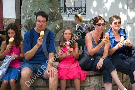Family eating ice cream in the town of Saint-Jean-de-Luz, Pyrenees-Atlantiques, French Basque Country, Southwest France.