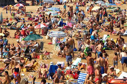 Crowded beach scene at Castro Urdiales, Cantabria, northern Spain.