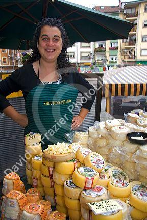 Spanish woman selling cheese at an outdoor market in the town of Cangas de Onis, Asturias, northern Spain.