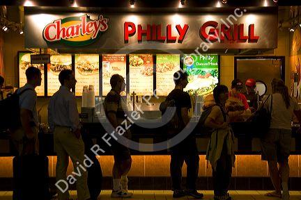 Travelers wait in line to purchase food from the Philly Grill fast food restaurant in the Minneapolis-Saint Paul International Airport at Minneapolis, Minnesota.