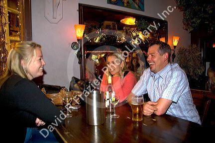 Customers socialize in an English pub in the city of Bath, Somerset, England.