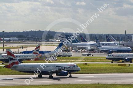 Airliners on the runway at London Heathrow Airport, England, United Kingdom.