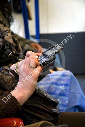 Woman texting on a cell phone in London, England.