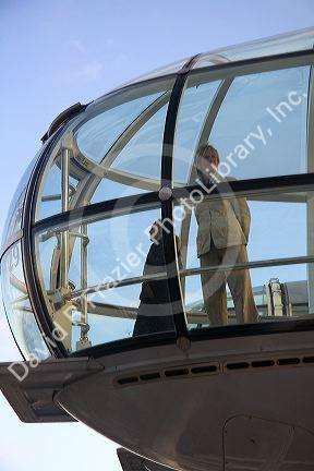 Tourists view the city of London from the London Eye, England.