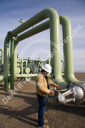 Operator turning a valve at a geothermal power plant in Malta, Idaho, USA. MR