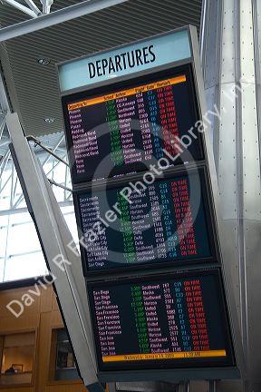 Airline departure notice board at the Portland International Airport in Portland, Oregon, USA.
