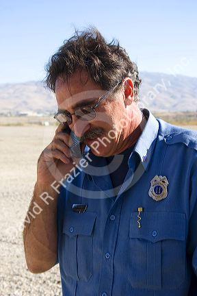 Captain Training Officer for the Boise Fire Department speaking on a cell phone in Boise, Idaho, USA.