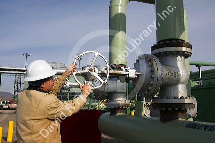 Operator turning a valve at a geothermal power plant in Malta, Idaho, USA. MR