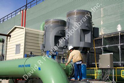 Operator checking a guage at a geothermal power plant in Malta, Idaho, USA. MR