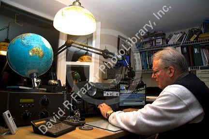 Ham radio operator in his radio shack located in Shelton, Washington, USA. MR