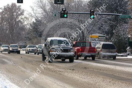 Automobiles driving in winter snow in Boise, Idaho, USA.
