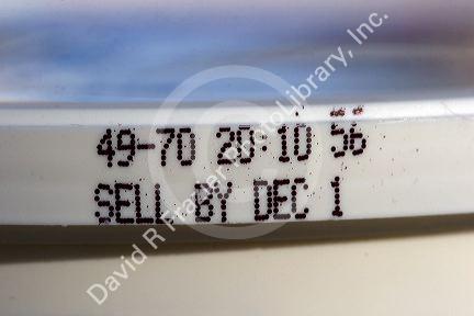 The sell by date on a pre-packaged food container.