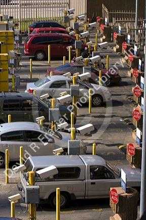 Automobiles being monitored by video cameras wait to enter the United States port of entry at the Tijuana, Baja California, Mexico/San Diego, California border crossing.