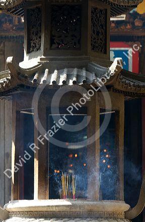 Burning incense outside the Jade Emperor Pagoda Buddhist temple in Ho Chi Minh City, Vietnam.