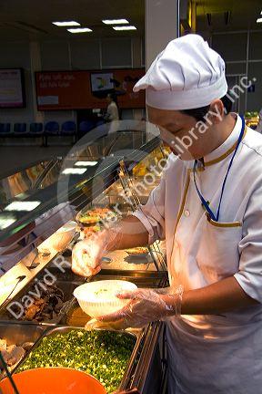 Chef making Pho, Vietnamese rice noodle soup in the Tan Son Nhat International Airport serving Ho Chi Minh City, Vietnam.