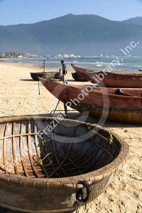 Woven boats and baskets on China Beach near the port city of Da Nang, Vietnam.