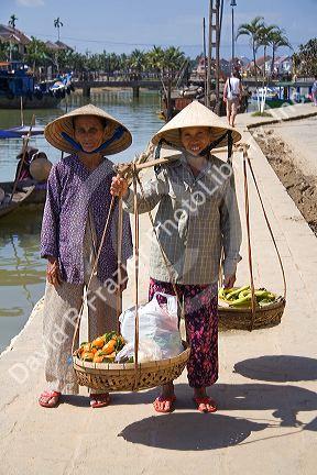 Vietnamese women selling produce along the Thu Bon River at Hoi An, Vietnam.