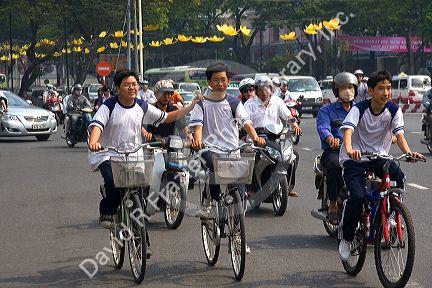 Vietnamese people ride bicycles and motorbikes in Ho Chi Minh City, Vietnam.