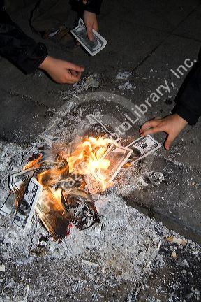 Vietnamese people burn photocopied U.S. dollars for good luck and prosperity in the coming year during Tet festivities in Hanoi, Vietnam.