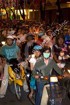 Vietnamese people ride motorbikes on Dong Khoi street during the last night of Tet Lunar New Year celebrations in Ho Chi Minh City, Vietnam.