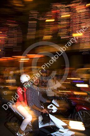 Vietnamese people ride motorbikes on Dong Khoi street during the last night of Tet Lunar New Year celebrations in Ho Chi Minh City, Vietnam.