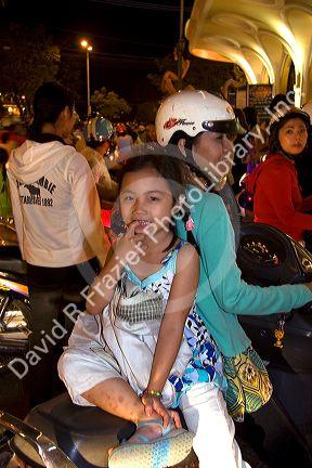 Vietnamese people ride motorbikes on Dong Khoi street during the last night of Tet Lunar New Year celebrations in Ho Chi Minh City, Vietnam.