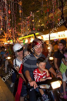 Vietnamese people ride motorbikes on Dong Khoi street during the last night of Tet Lunar New Year celebrations in Ho Chi Minh City, Vietnam.
