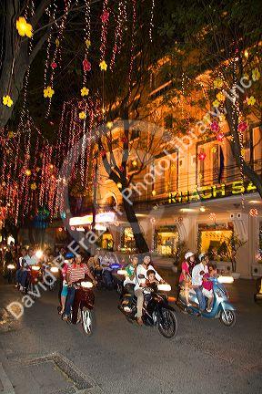 Vietnamese people ride motorbikes on Dong Khoi street during the last night of Tet Lunar New Year celebrations in Ho Chi Minh City, Vietnam.