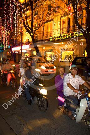 Vietnamese people ride motorbikes on Dong Khoi street during the last night of Tet Lunar New Year celebrations in Ho Chi Minh City, Vietnam.