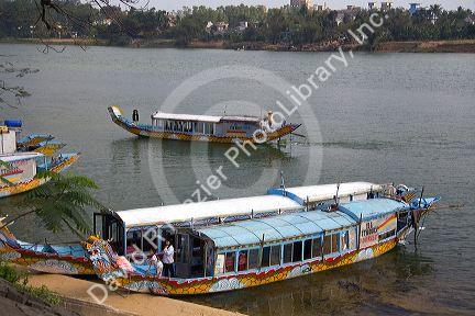 Tourist boats on the Perfume River in front of the Thien Mu Pagoda  in Hue, Vietnam.