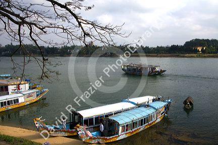 Tourist boats on the Perfume River in front of the Thien Mu Pagoda  in Hue, Vietnam.