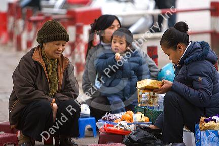 Vietnamese family having a picnic during Tet festivities in Hanoi, Vietnam.