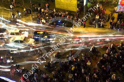 Motion of motorbikes moving through crowds of people celebrating Tet in Hanoi, Vietnam.