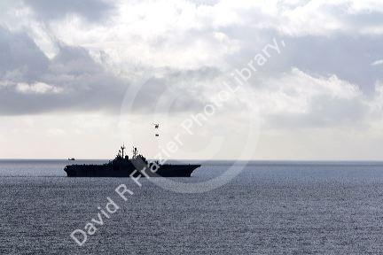 USS Bonhomme Richard Amphibious Assault Ship of the United States Navy being resupplied by helicopter in the Pacific Ocean near Camp Pendleton, California, USA.