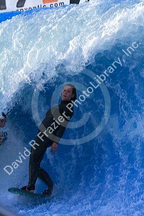 Woman surfing on a man made wave machine at Mission Beach, San Diego, Southern California, USA. MR