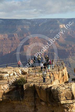 Tourists view the South Rim of the Grand Canyon, Arizona, USA.
