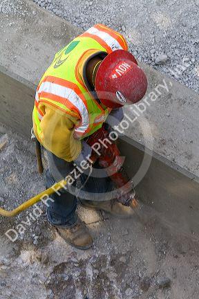 Construction worker using a jackhammer in downtown Chicago, Illinois, USA.