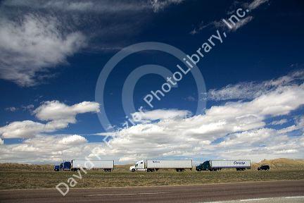 Long haul trucks traveling on Interstate 80 in Carbon County, Wyoming, USA.