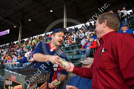 Vendor selling hot dogs during a Cubs baseball game at Wrigley Field in Chicago, Illinois, USA.
