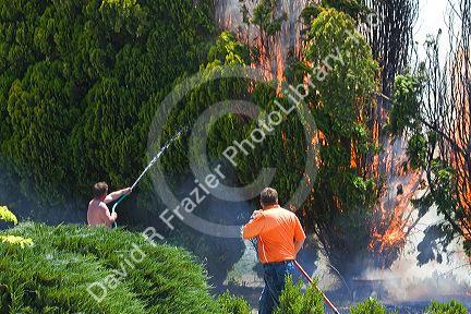 Homeowners try to put out a residential fire in Canyon County, Idaho, USA.