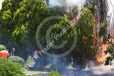 Homeowners try to put out a residential fire in Canyon County, Idaho, USA.